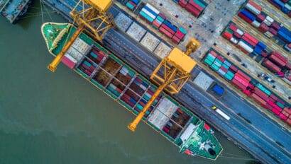container-ship-carrying-container-for-import-and-export-aerial-view-business-logistic-and-freight-transportation-by-ship-in-open-sea