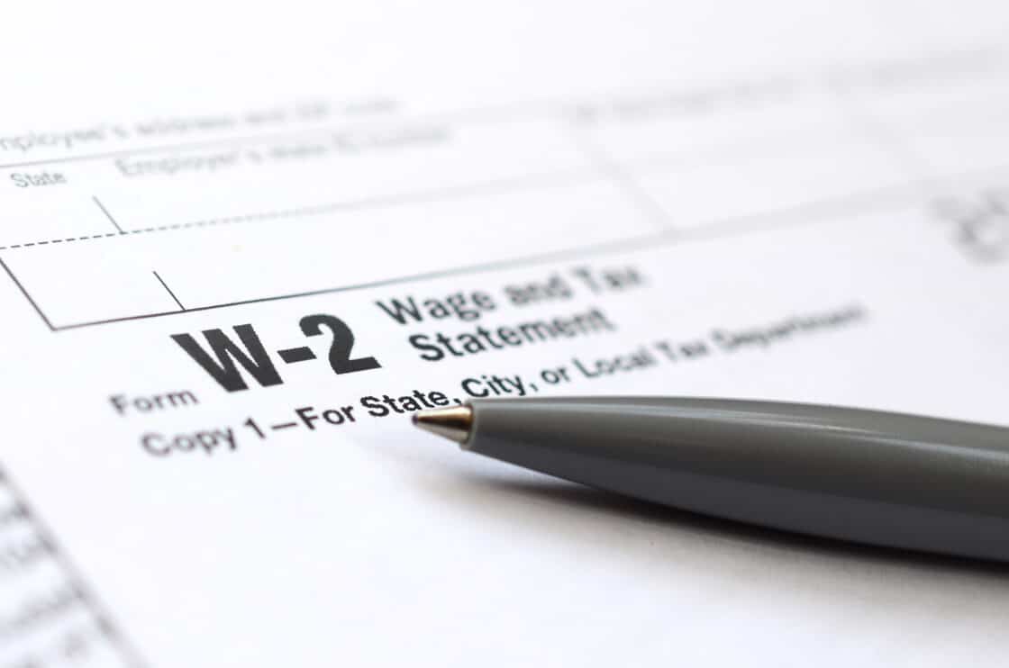 the-pen-lies-on-the-tax-form-w-2-wage-and-tax-statement-the-tim