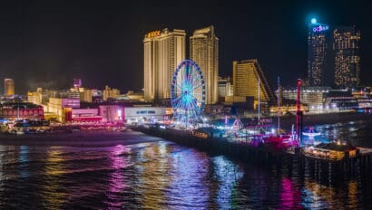 panoramic-aerial-view-of-the-broadwalk-on-the-waterfront-in-atlantic-city-downtown-the-famous-gambling-center-of-the-east-coast-usa-with-multiple-casinos-and-amusing-park-with-a-ferris-wheel-on-a-pi