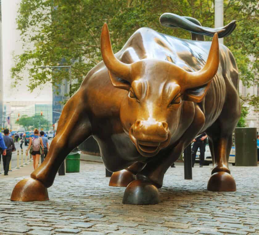 A sculpture of a charging bull.