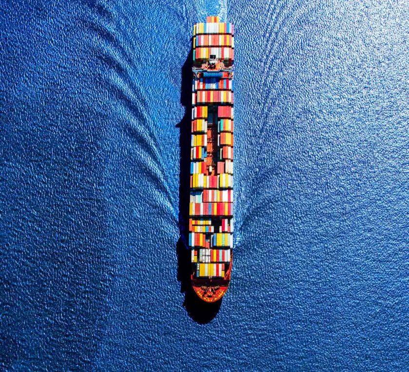 An aerial view of a container ship at sea.