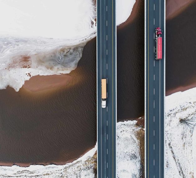 An aerial view of two parallel roads over a river.