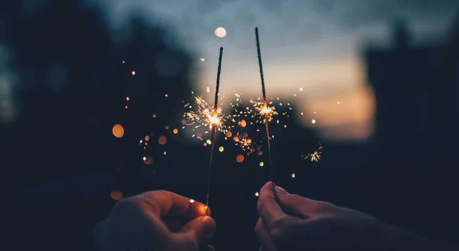Two people holding sparklers.