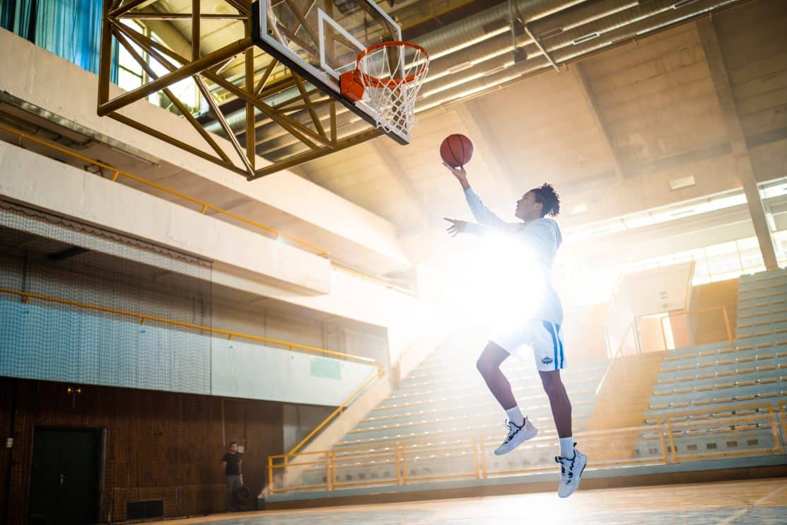 basketball-player-throwing-ball-in-hoop