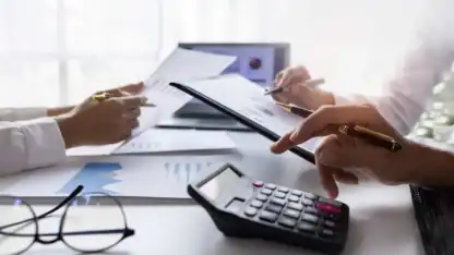 a work office with laptop and a calculator.