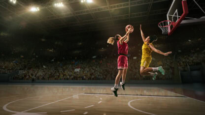 Female basketball players competing on the court.