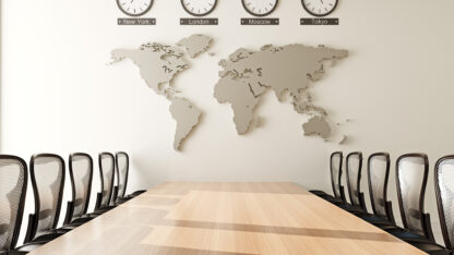 A boardroom table with chairs in front of a world map and clocks displaying the times in New York, London, Moscow, and Tokyo.