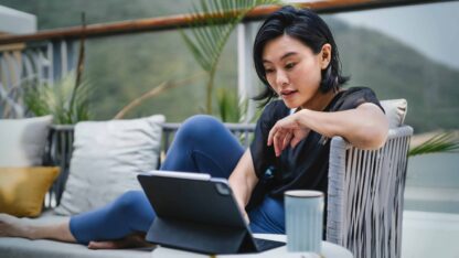 Young woman using computer for business to analyze financial statements