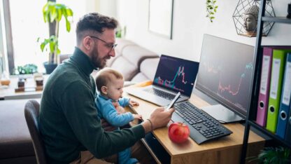 Individual and child sitting at computer, planning for future