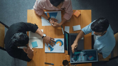 A team of business people sitting at a conference table reviewing documents