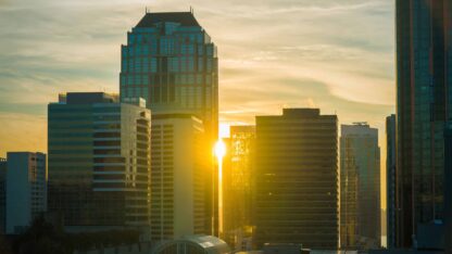 Sunset through city skyscrapers