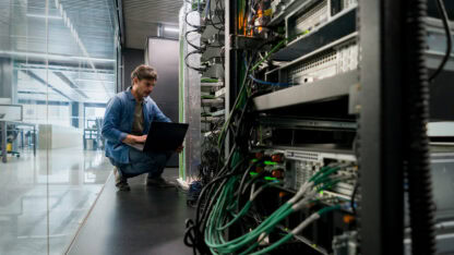 Computer technician checking a network server at an office