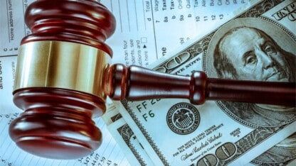 Gavel, dollars, and documents representing IRS penalty and tax court reforms