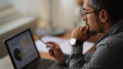 Marketing firm leader working on financial report of operations, revenue