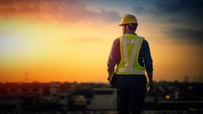 Engineer on a real estate construction site at sunset