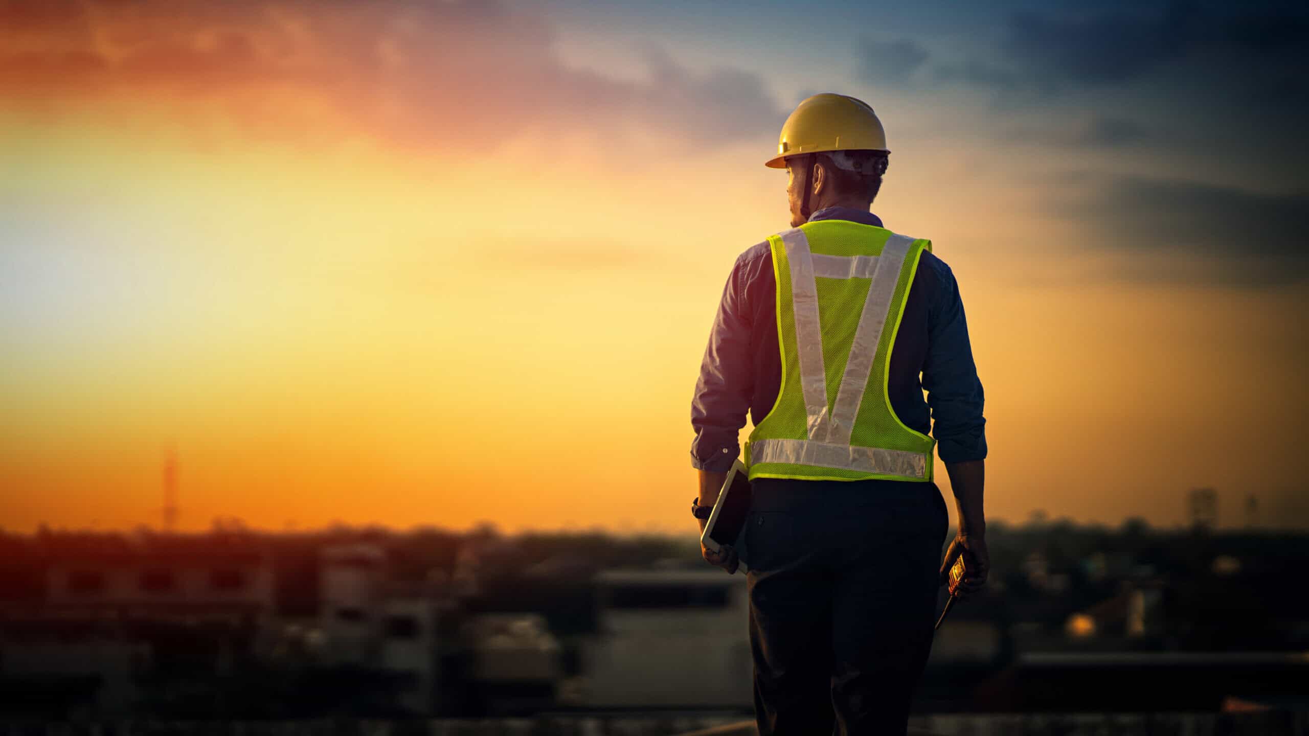 Engineer on a real estate construction site at sunset