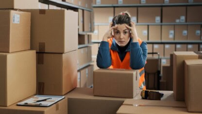 Image of woman stressed with boxes
