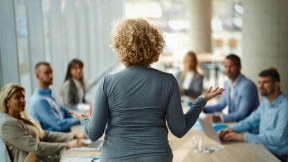 CEO talking to her team in the office about succession planning