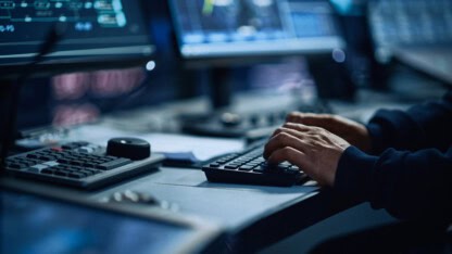 Active hands on keyboard representing fraud risks to Tribal casinos from cybercriminals