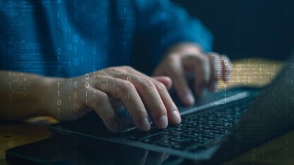 Image of fingers typing on a keyboard representing the need for a measurable cybersecurity program