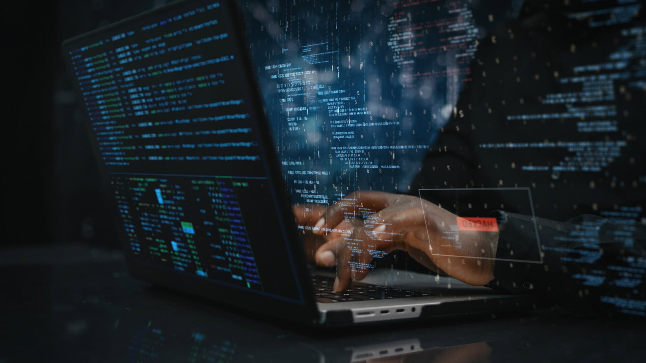 Hands of male sitting in front of computer, writing on keyboard focused on hacking