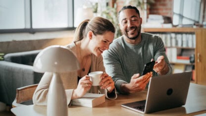 Two individuals using online tools to assess their professional service firm's cash flow health