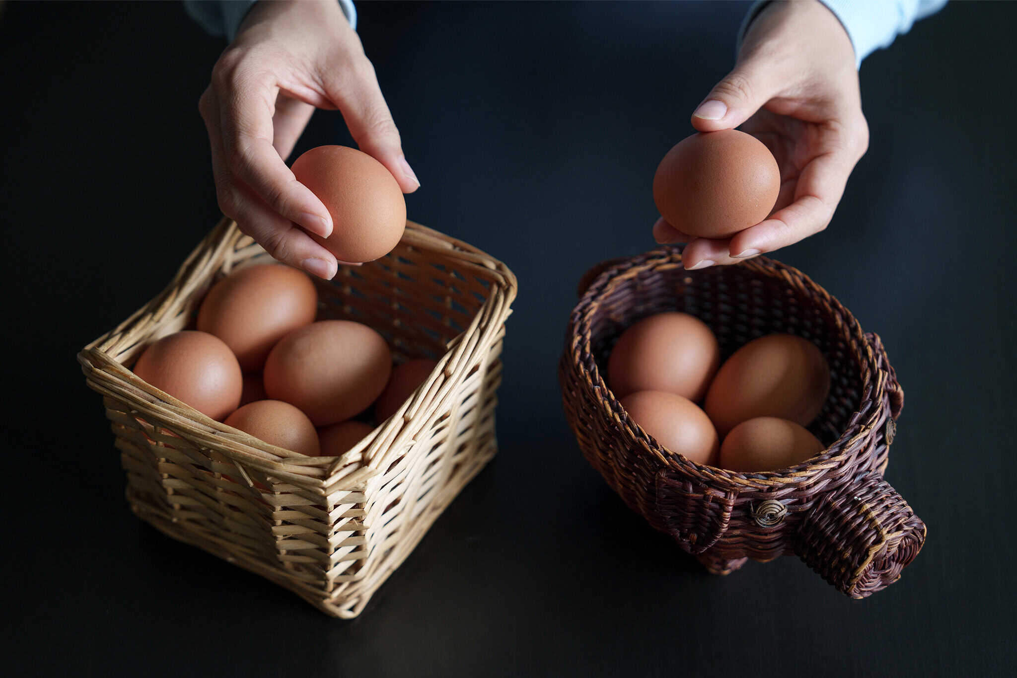 Eggs being held above a pair of baskets representing rules for handling forfeiture accounts