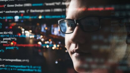 Close-up of software engineers, programmers and cybersecurity technology