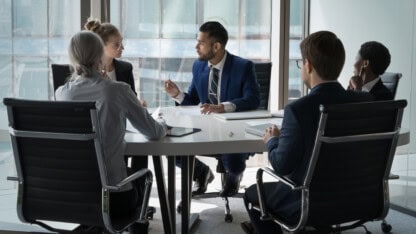 Boardroom of professionals discussing international tax considerations