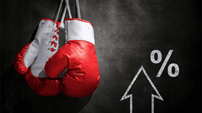 Image of boxing gloves and percentage arrow pointing up, representing how the revised tax rate in 2026 may increase liability