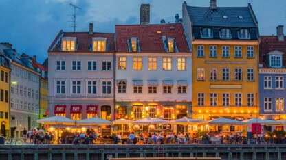 People eating by a waterfront in an international city