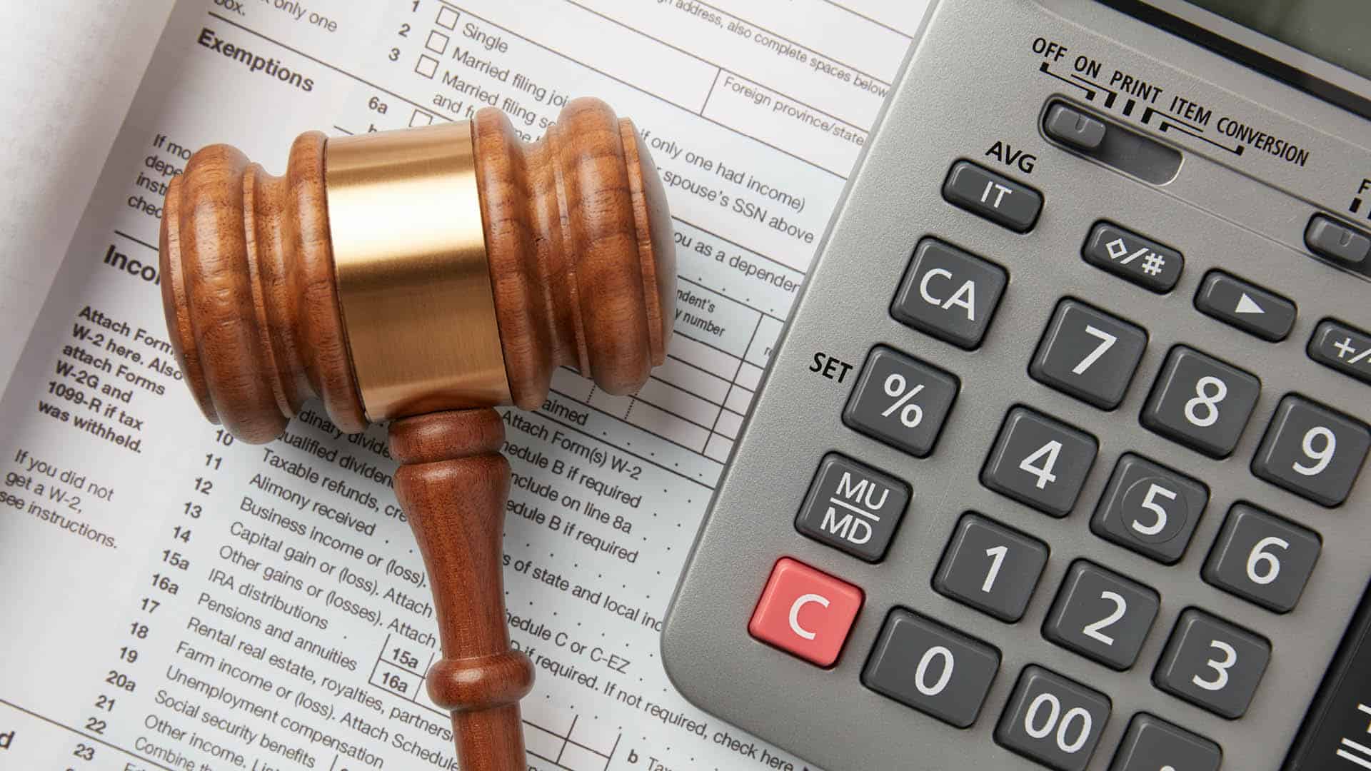 Gavel and calculator over reporting documents representing new IRS Section 987 regulations