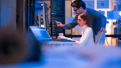 Professionals monitoring multiple screens for cybersecurity